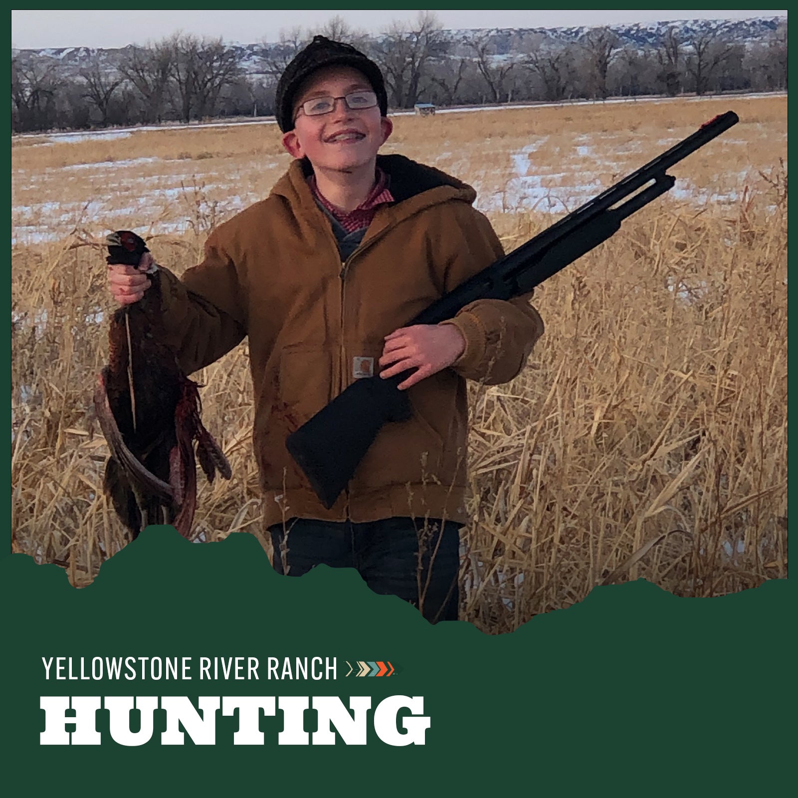 Young boy in a field holding a rifle and a pheasant
