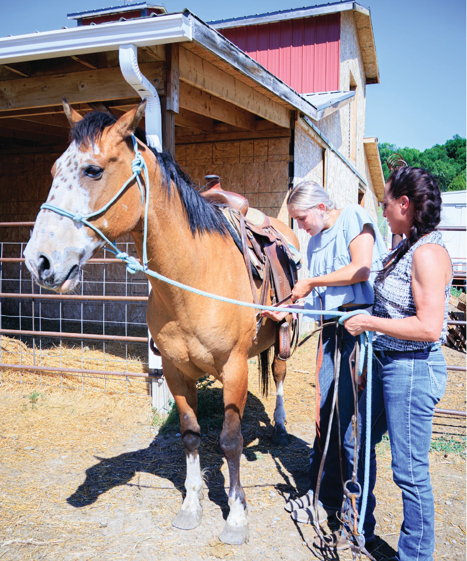 Two women preparing a horse for riding at Yellowstone River Ranch 