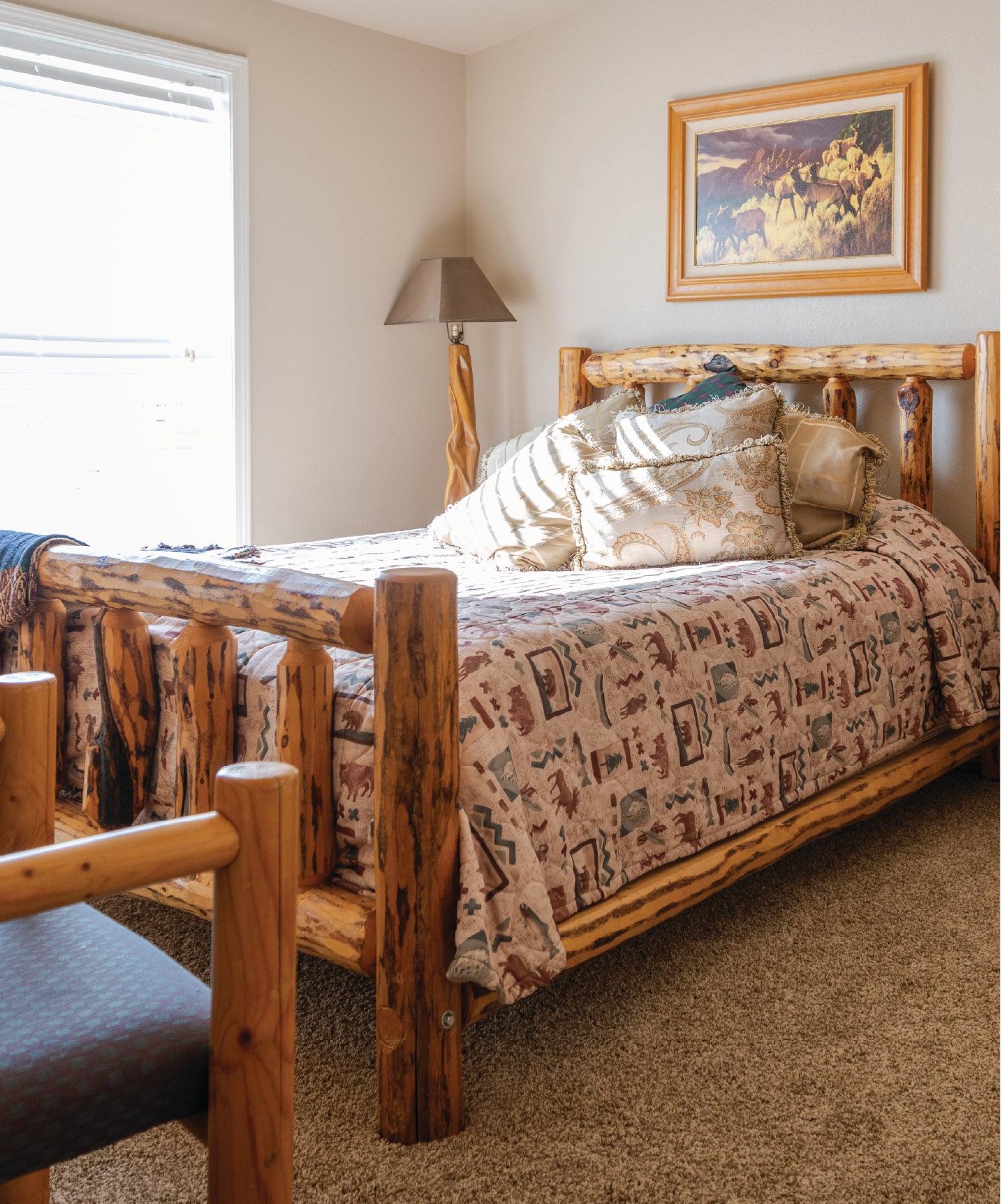 Bedroom with wooden bed and patterned bedding