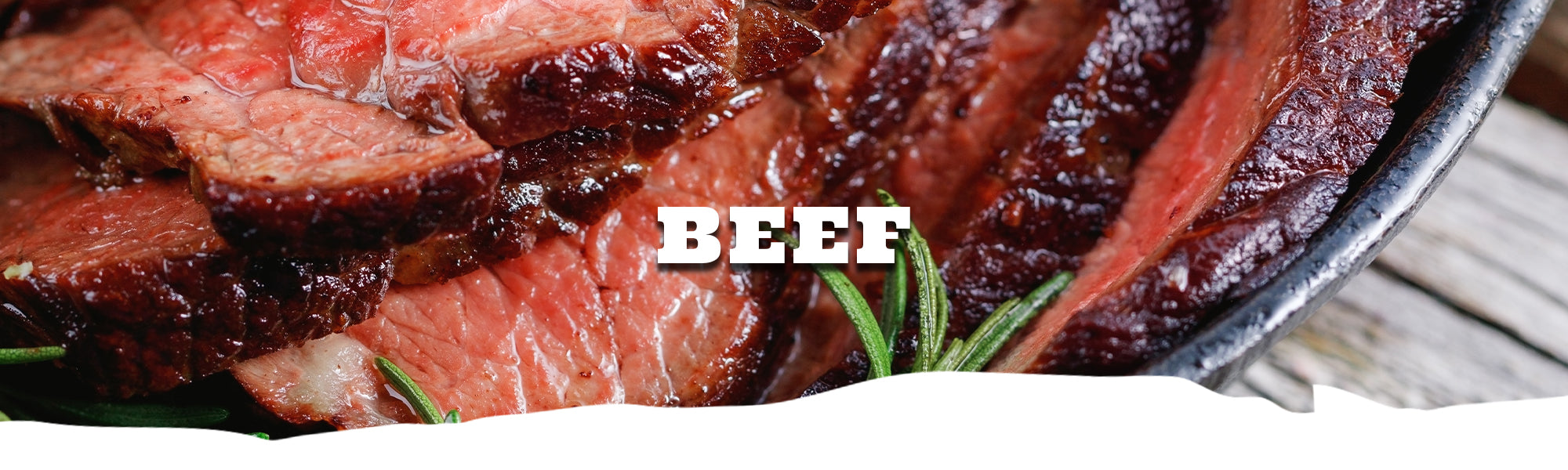 Sliced beef with rosemary on a pan, labeled 'BEEF'.