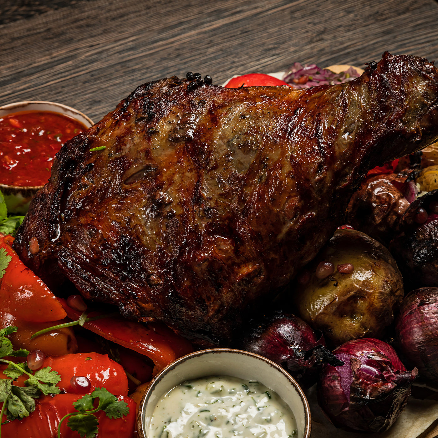 Roasted lamb dish with vegetables on a wooden surface