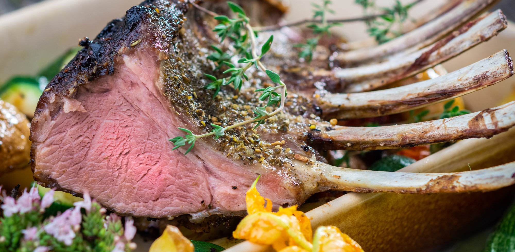 Roasted rack of lamb with herbs on a plate
